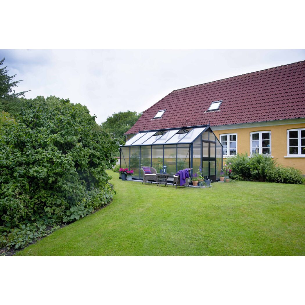 Gewächshaus im Garten mit Sitzmöbeln