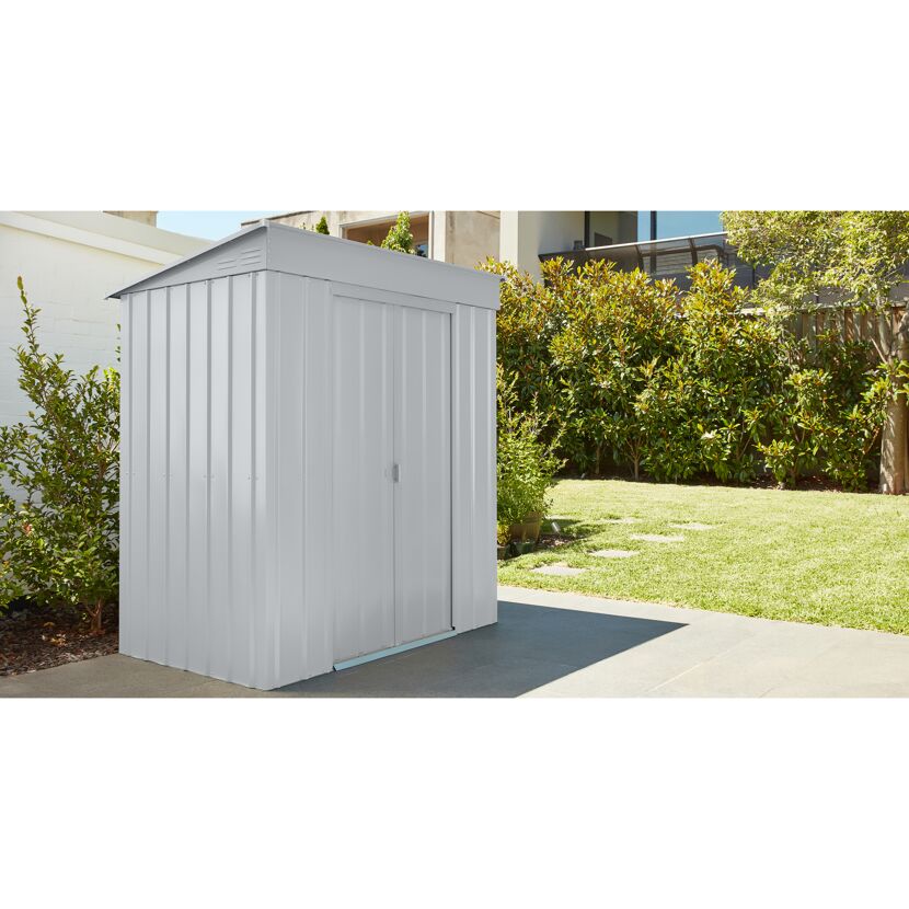 Graues Gerätehaus aus Metall im Garten.