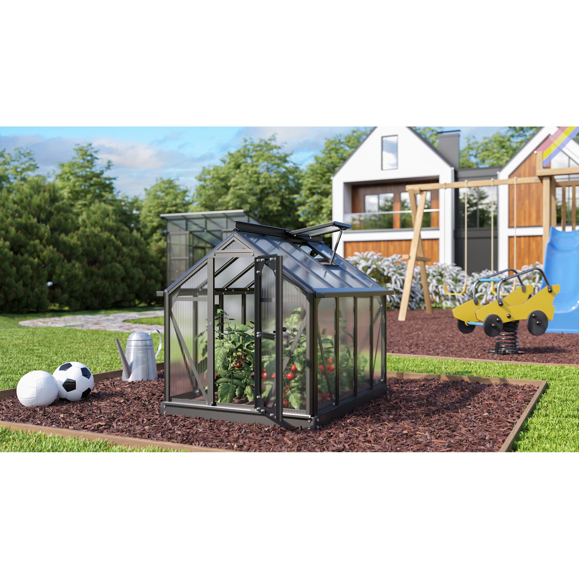 Kleines Gewächshaus mit Tomatenpflanzen im Garten