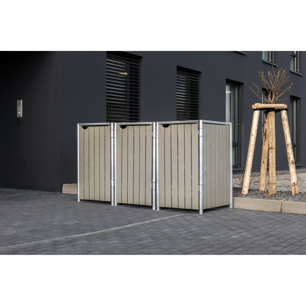 Zwei Mülltonnenboxen vor einem Gebäude.