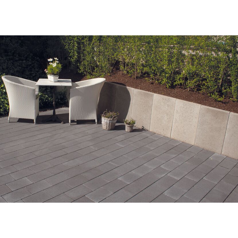 Gepflasterte Terrasse mit Sitzecke und Hochbeet