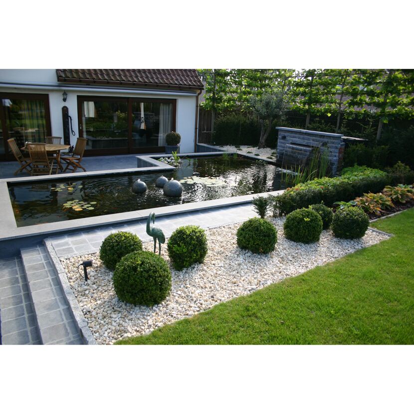 Moderner Gartenteich mit Wasserfall und Dekorationen.