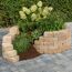 Mauerstein 'T-Wall Rustic' als Hochbeet mit Pflanzen und Blumen.