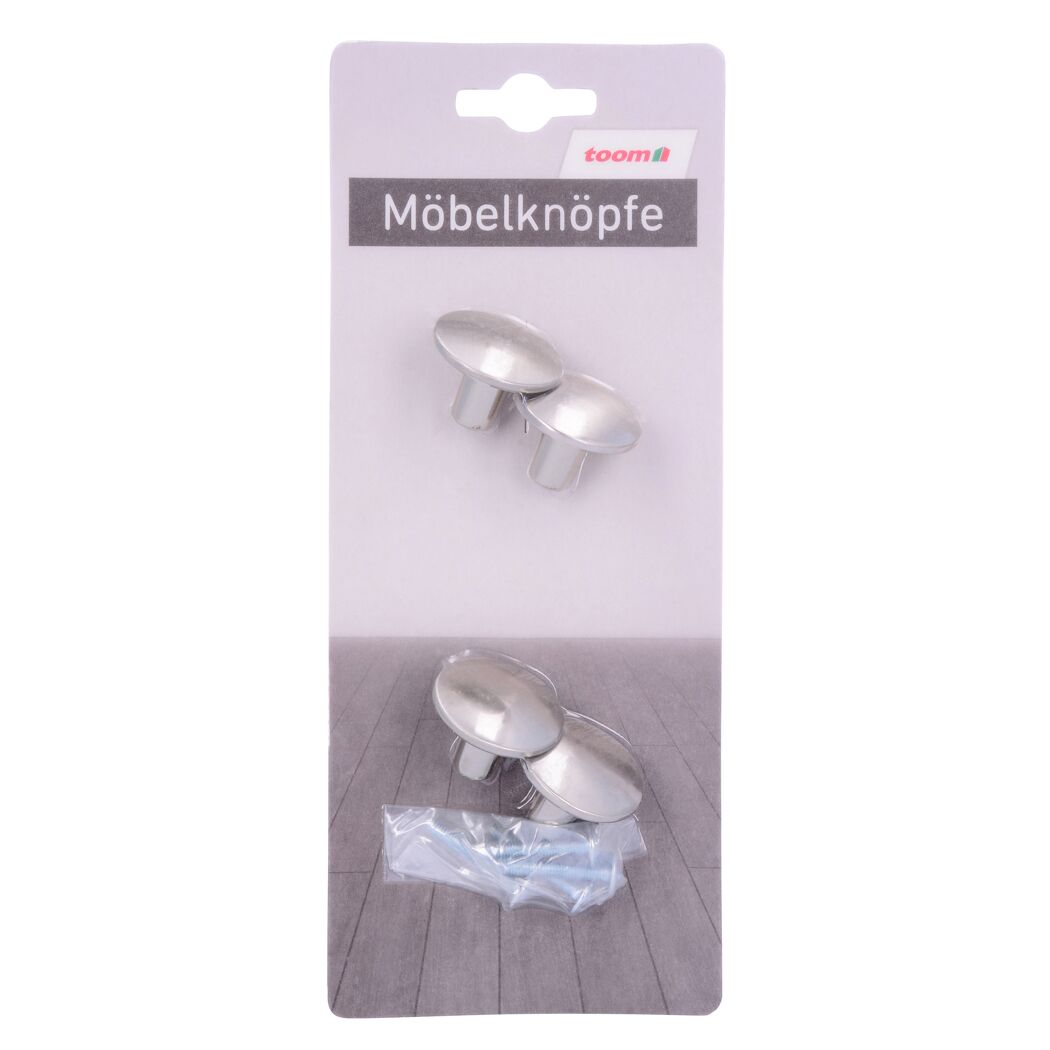 Vier silberne Möbelknöpfe und Schrauben in Verpackung.