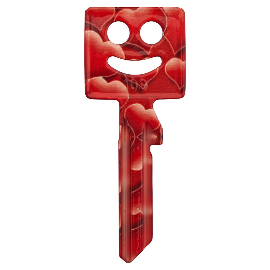 Roter Schlüssel mit Herzmotiv und lachenden Gesicht.