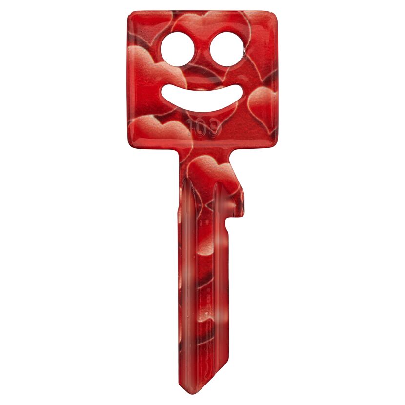 Roter Schlüssel mit Herzmotiv und lachenden Gesicht.