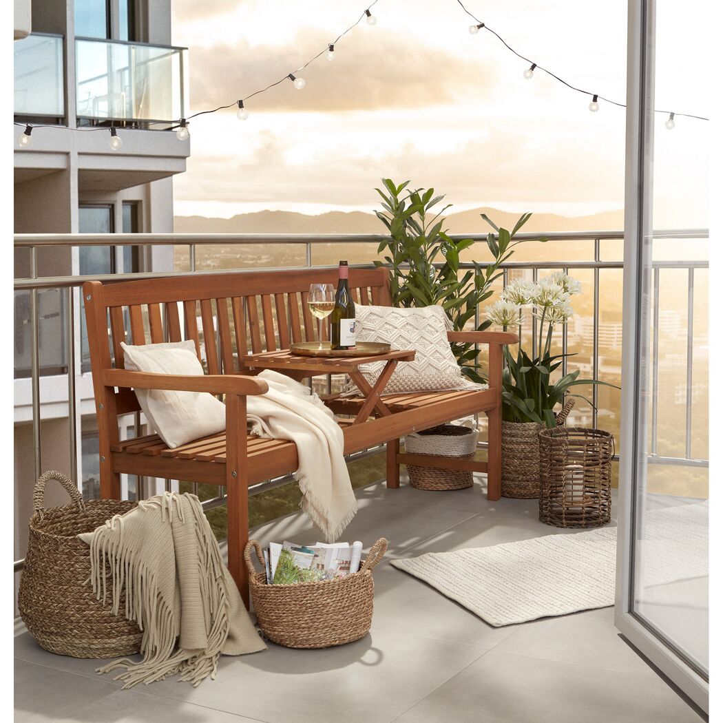 Holzbank mit Tisch auf Balkon, Deko, Korb und Pflanzen