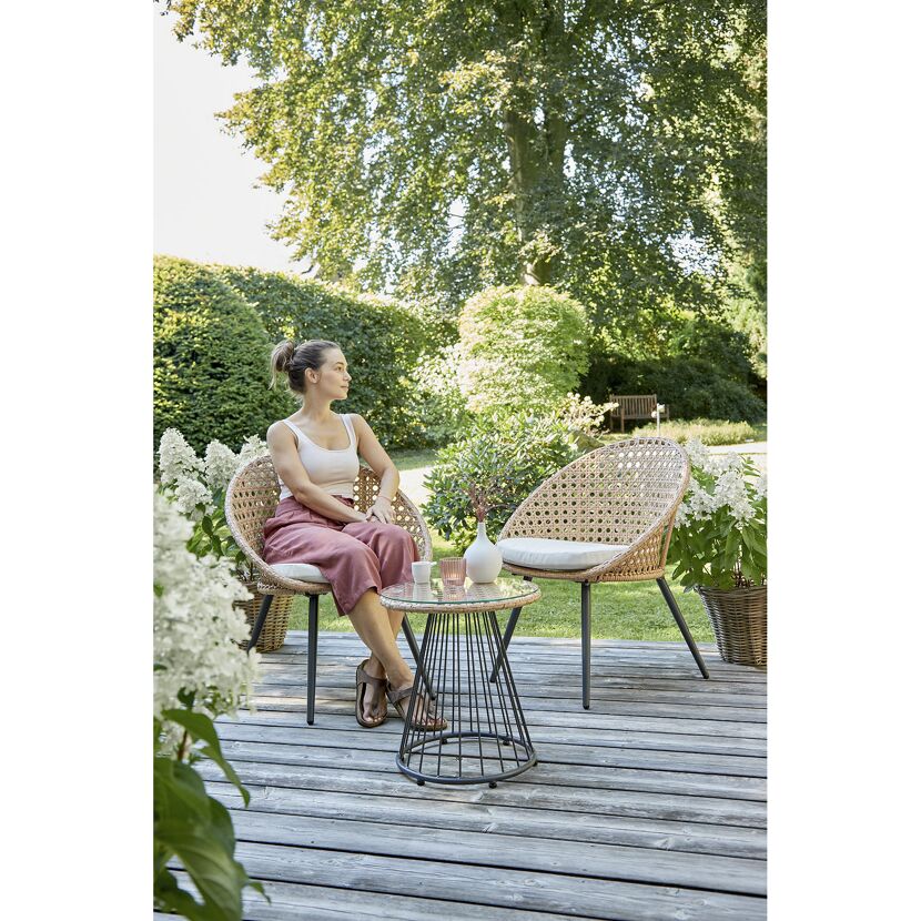 Person sitzt auf Gartenstuhl am Tisch
