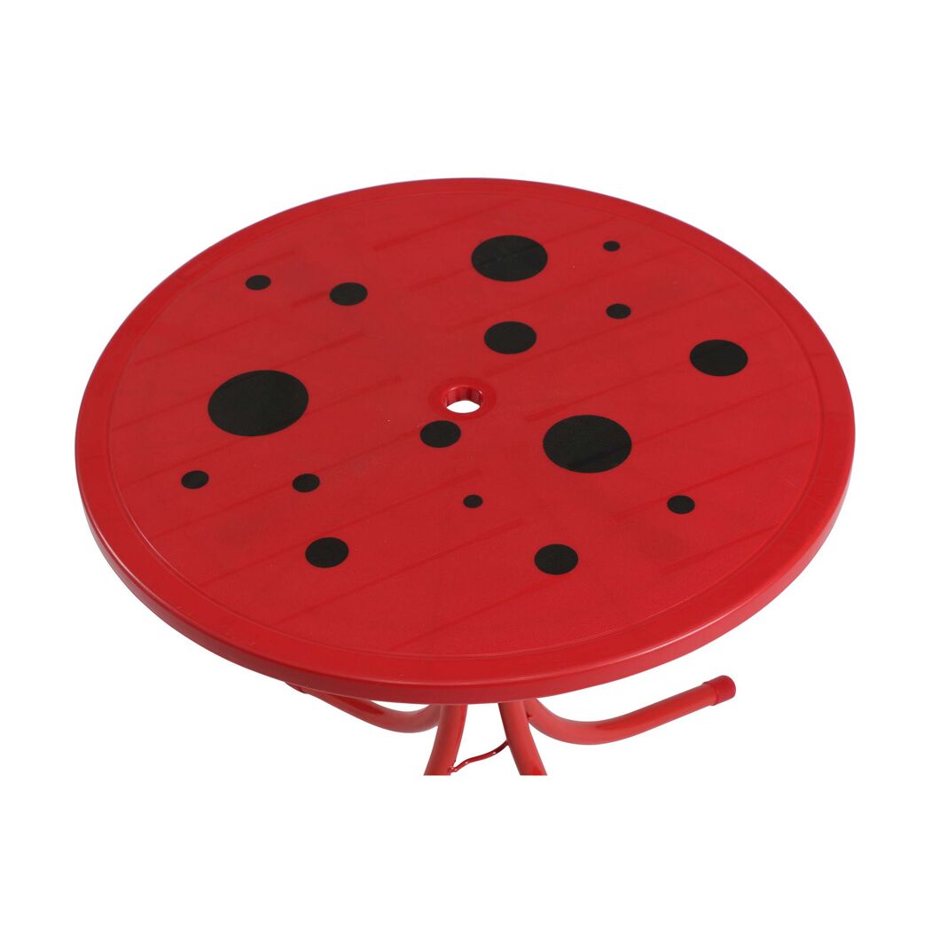 Roter Kindertisch mit schwarzen Punkten