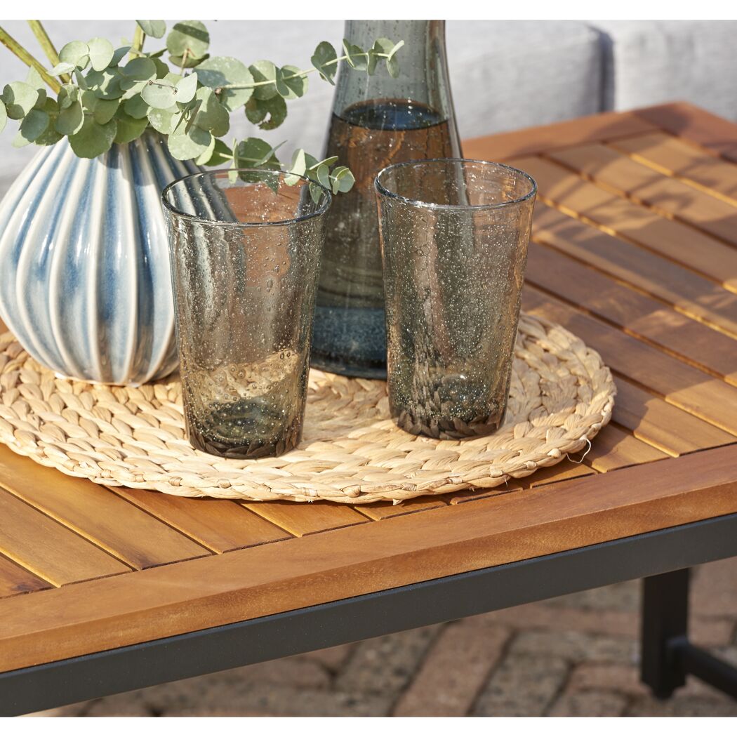 Zwei Gläser und eine Vase auf einem Gartentisch