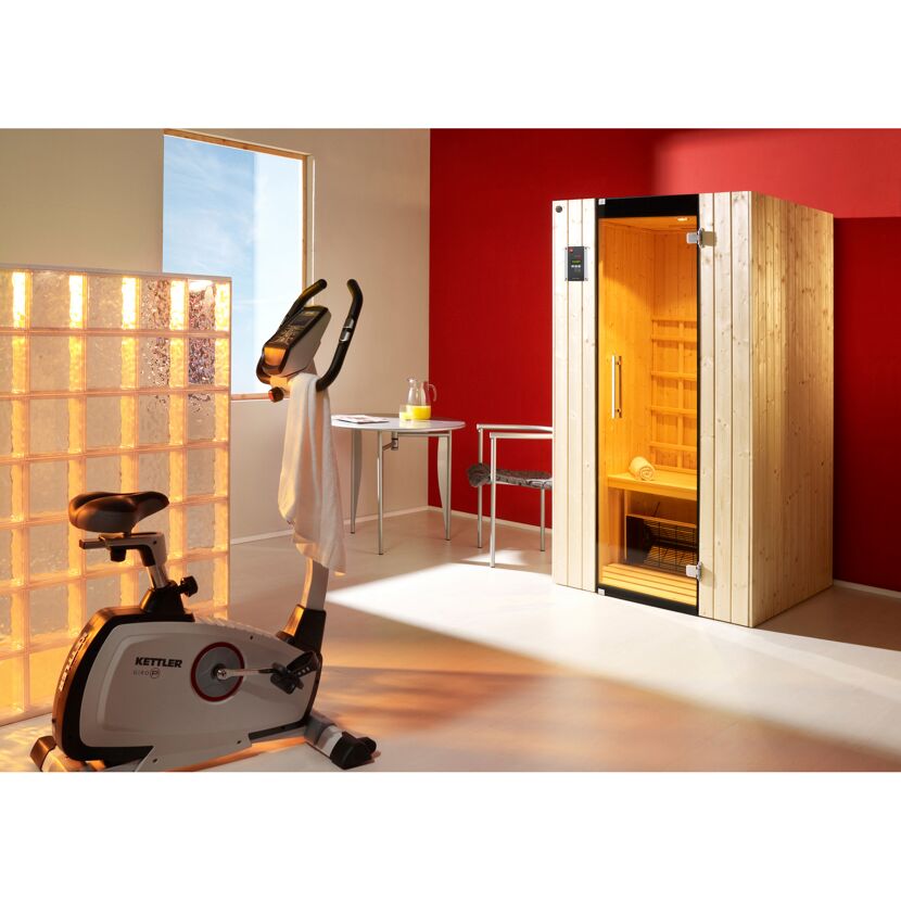 Heimsauna neben einem Heimtrainer