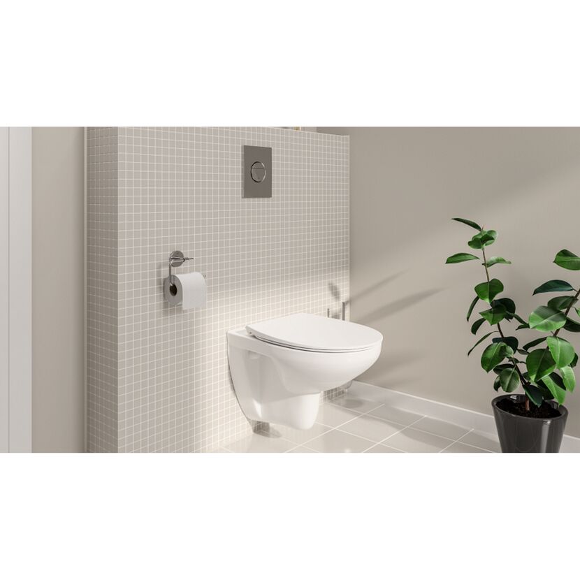 Hängendes, weißes WC mit Spülkasten und Toilettenpapierhalter an beigefarbener Fliesenwand.
