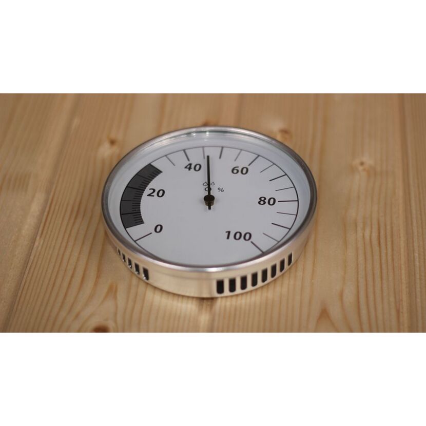 Analoges Hygrometer auf Holztisch.
