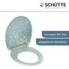 Geöffneter, mintgrüner WC-Sitz mit weißem Blumenmuster.