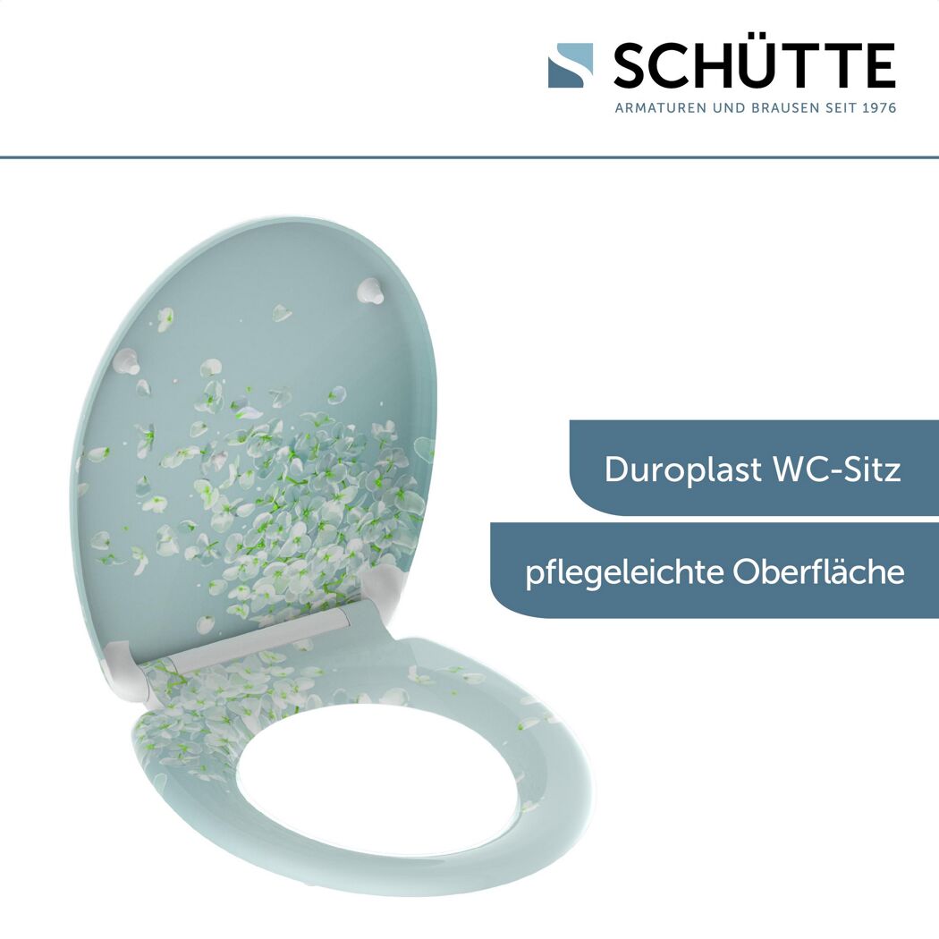 Geöffneter, mintgrüner WC-Sitz mit weißem Blumenmuster.