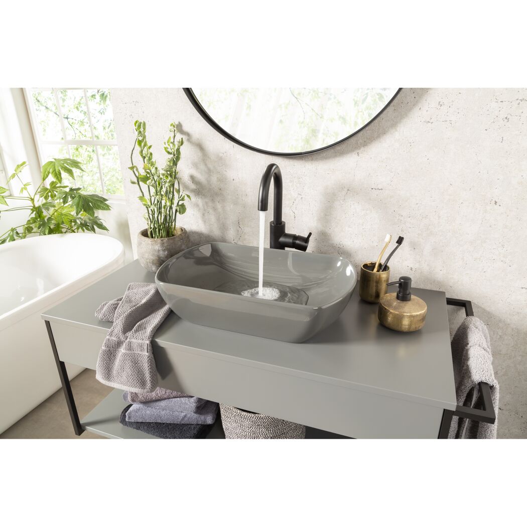 Graues Waschbecken mit laufendem Wasserhahn