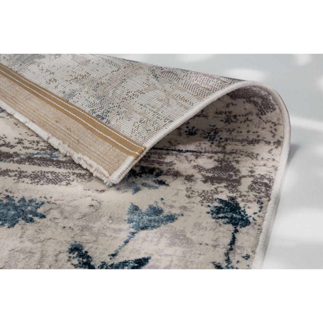 Beigefarbener Teppich mit blauem Muster