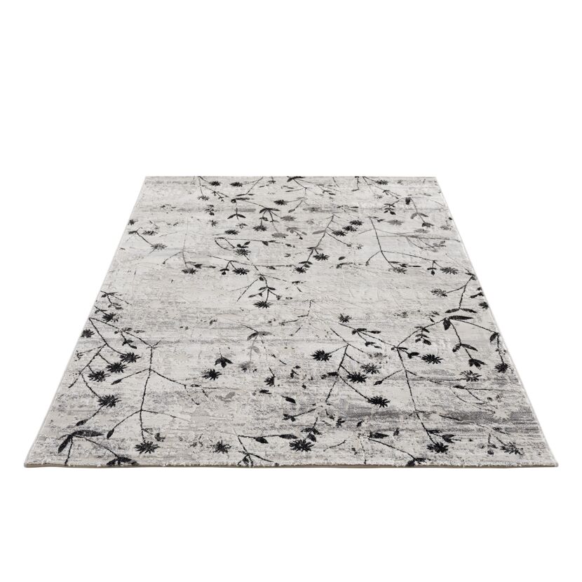 Beiger Teppich mit schwarzem Blumenmuster