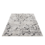 Beiger Teppich mit schwarzem Blumenmuster