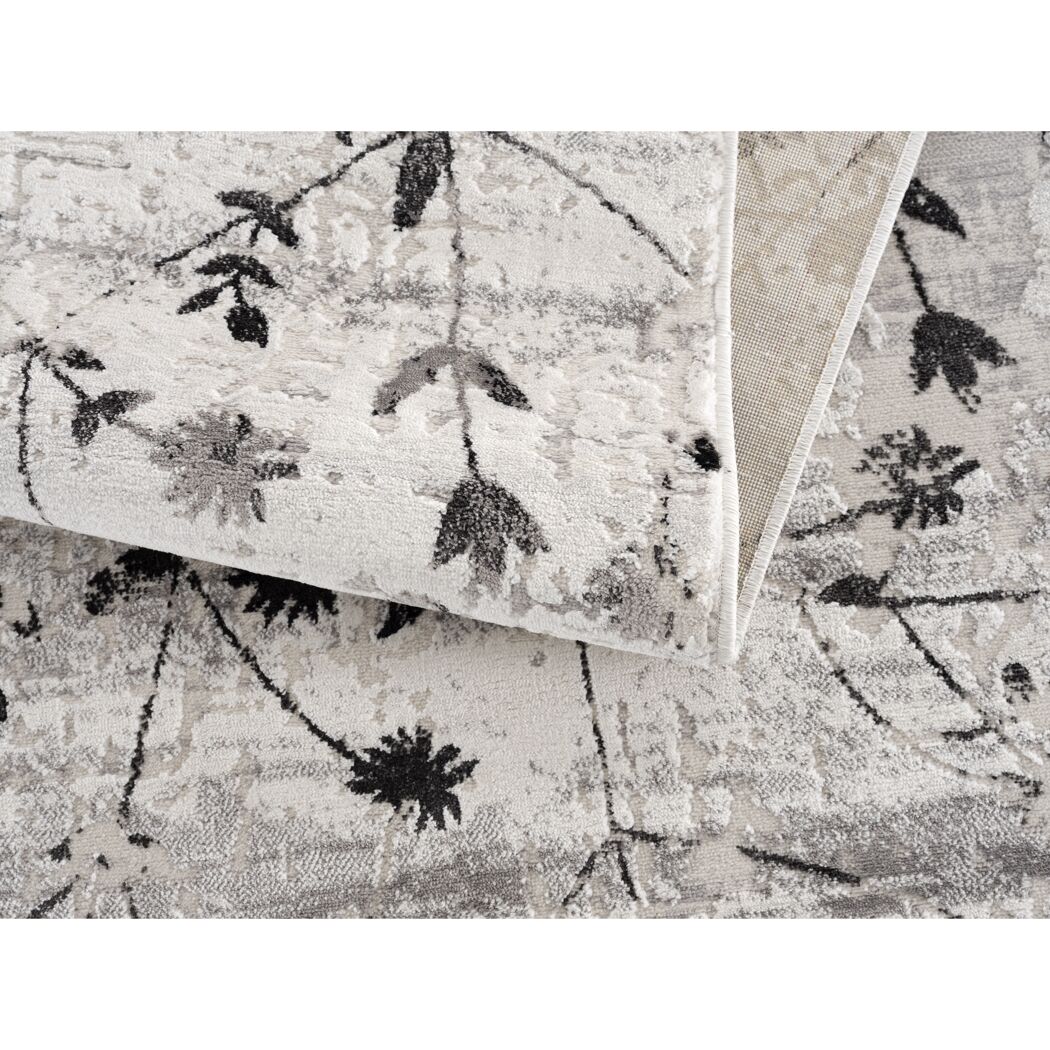 Beiger Teppich mit schwarzem Blumenmuster