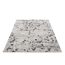 Beiger Teppich mit schwarzem Blumenmuster