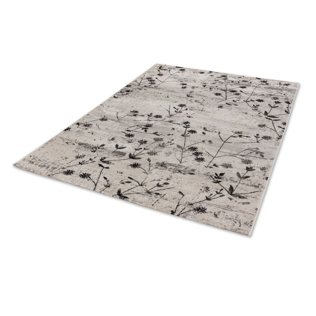 Beiger Teppich mit schwarzem Blumenmuster