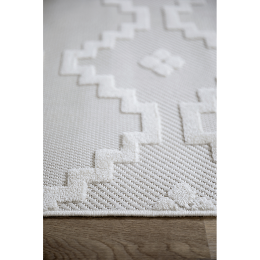 Cremefarbener Teppich mit geometrischem Muster