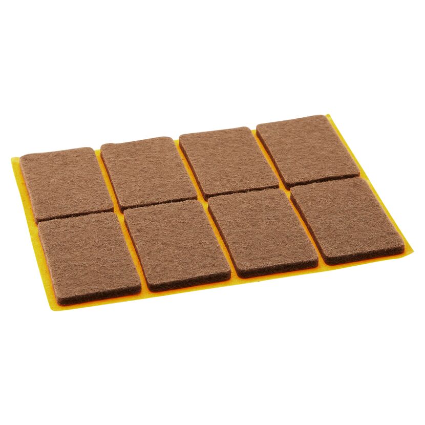 Selbstklebende braune Filzgleiter auf gelbem Trägerpapier