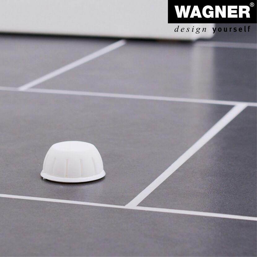 Weißer Türstopper auf grauem Fliesenboden