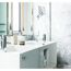 Waschbecken mit zwei Wasserhähnen und Handtüchern