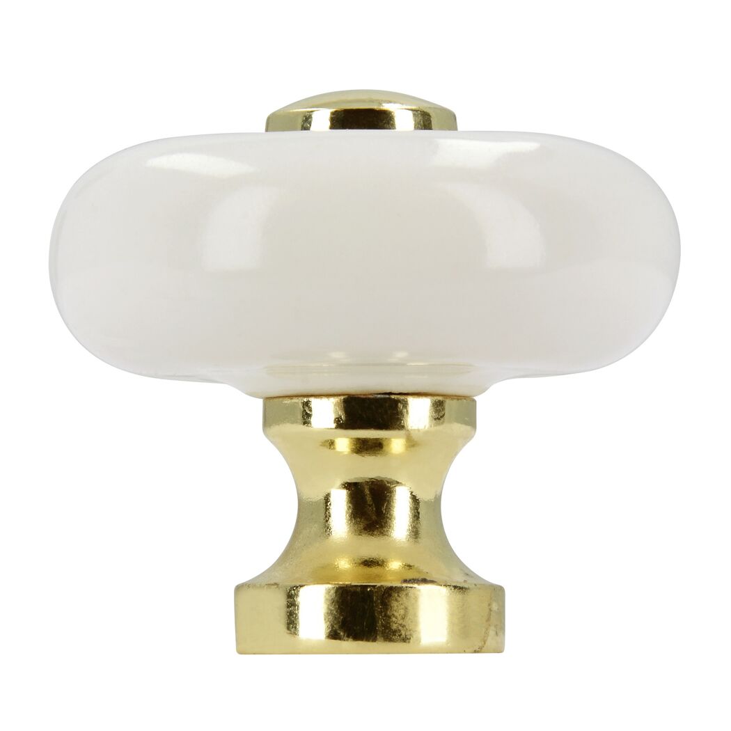 Weißer Möbelknopf mit goldener Fassung.