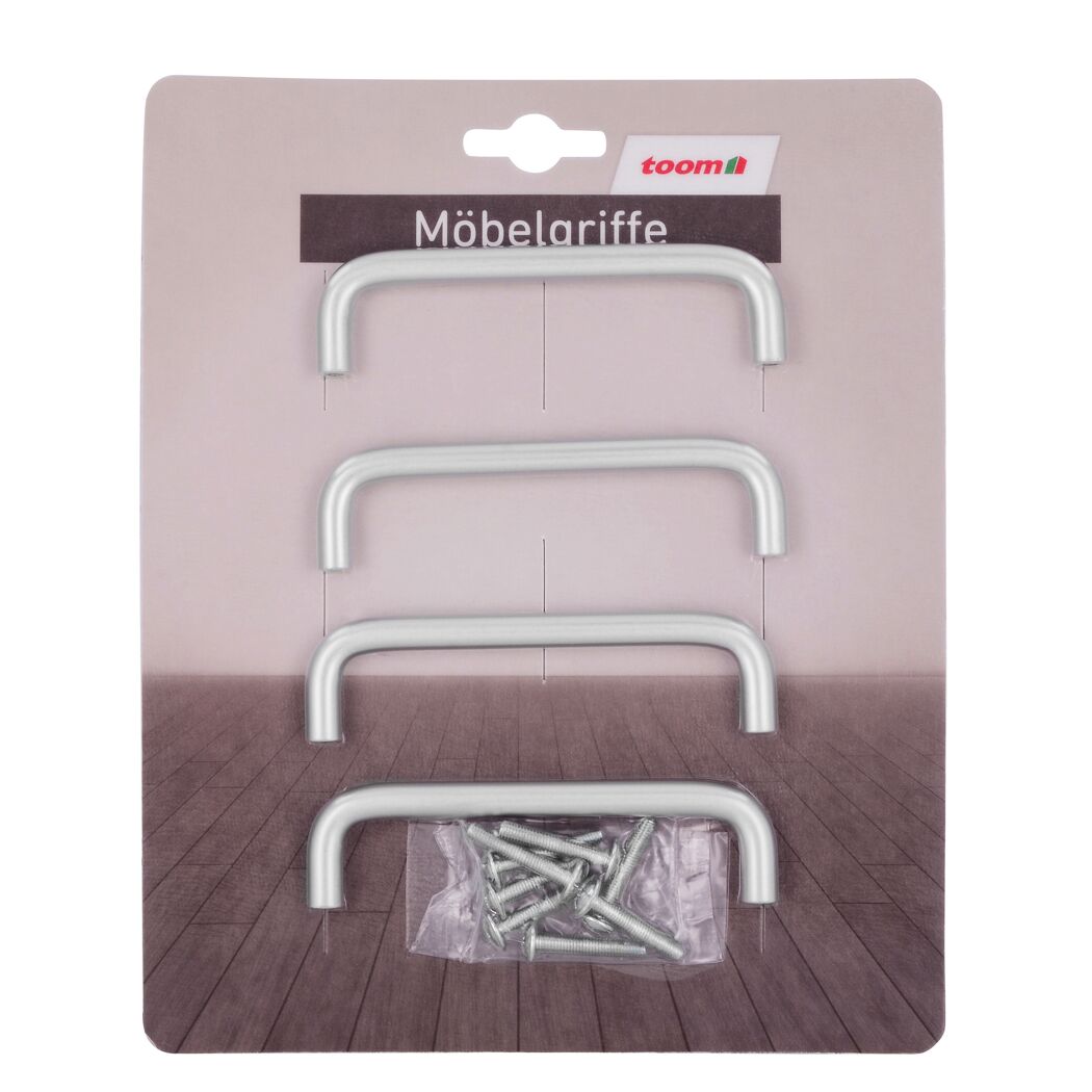 Vier silberne Möbelgriffe und Schrauben in einer Verpackung.