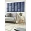 Blaues Wandkissen Inari an der Wand über einem Sofa