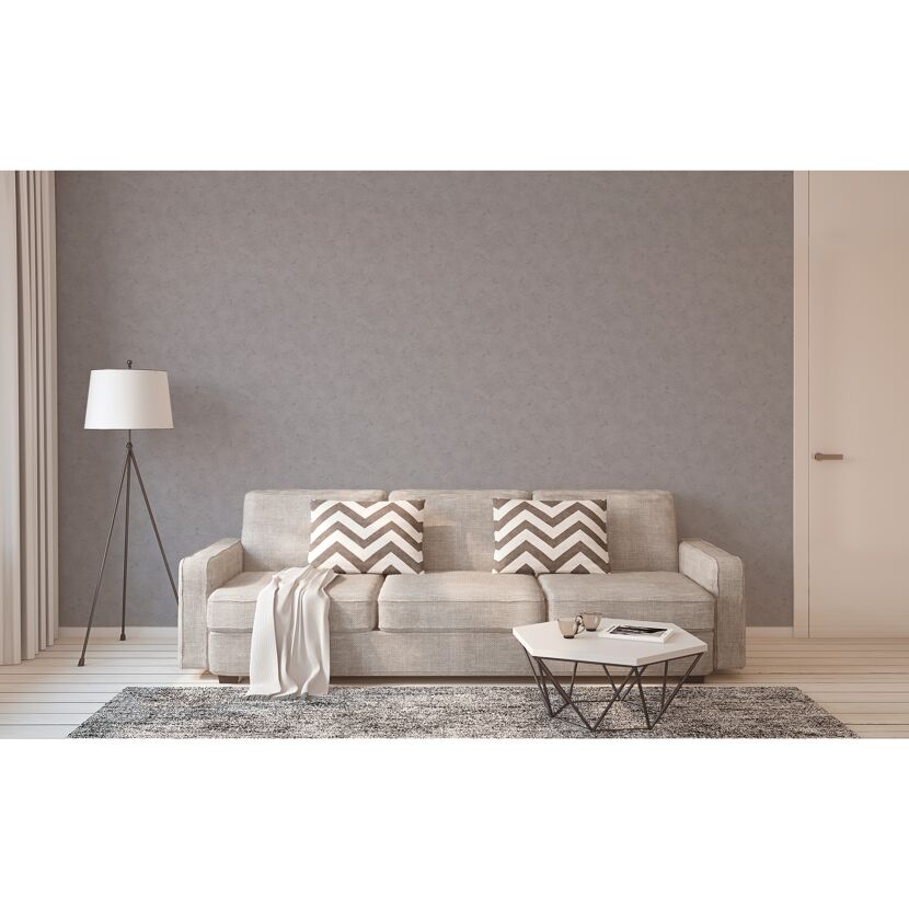 Modernes Wohnzimmer mit grauem Sofa, Teppich und Stehlampe.
