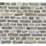 Graue und beige Ziegelwand