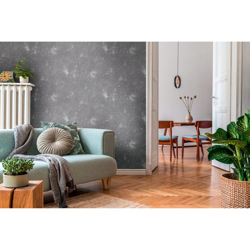 Wohnzimmer mit mintgrüner Couch und grauer Vliestapete