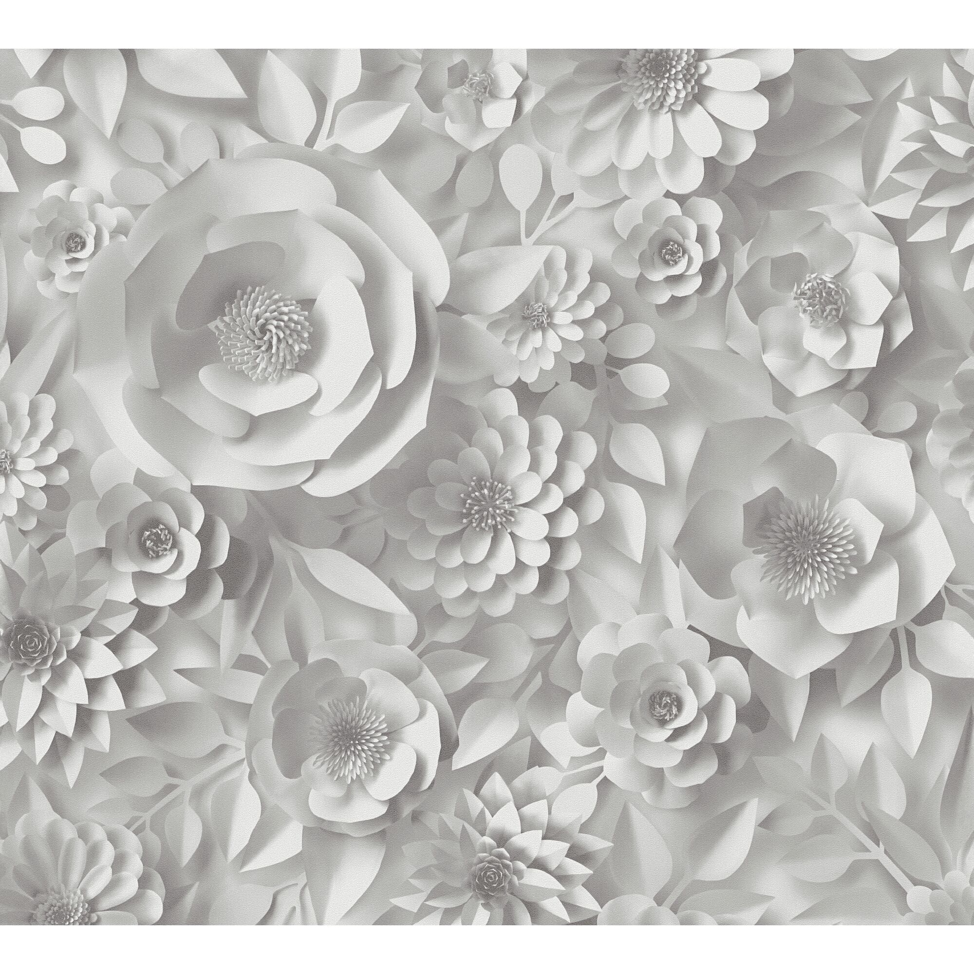 Weiße Papierblumen auf grauem Hintergrund.