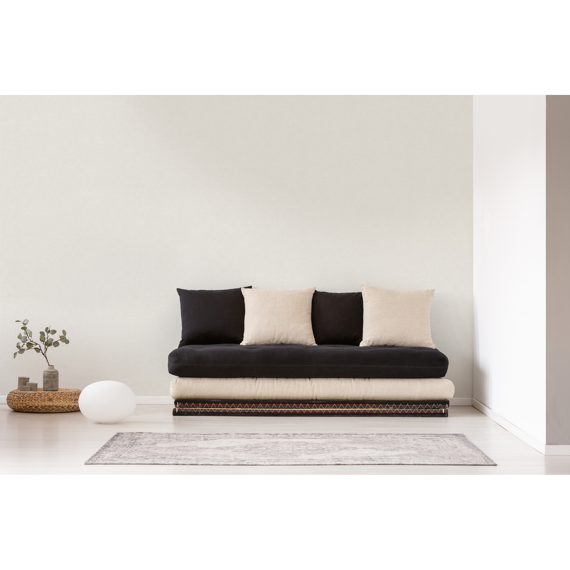 Futon Sofa mit schwarzen und beigen Kissen