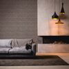 Wohnzimmer mit grauer Couch, brauner Vliestapete und Kamin