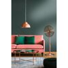 Wohnzimmer mit rosafarbenem Sofa, Ventilator und kupferfarbenen Akzenten