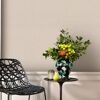 Beige Vliestapete an der Wand. Blumenstrauß und ein moderner Stuhl