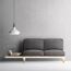 Graues Sofa vor Wand mit floralem Muster