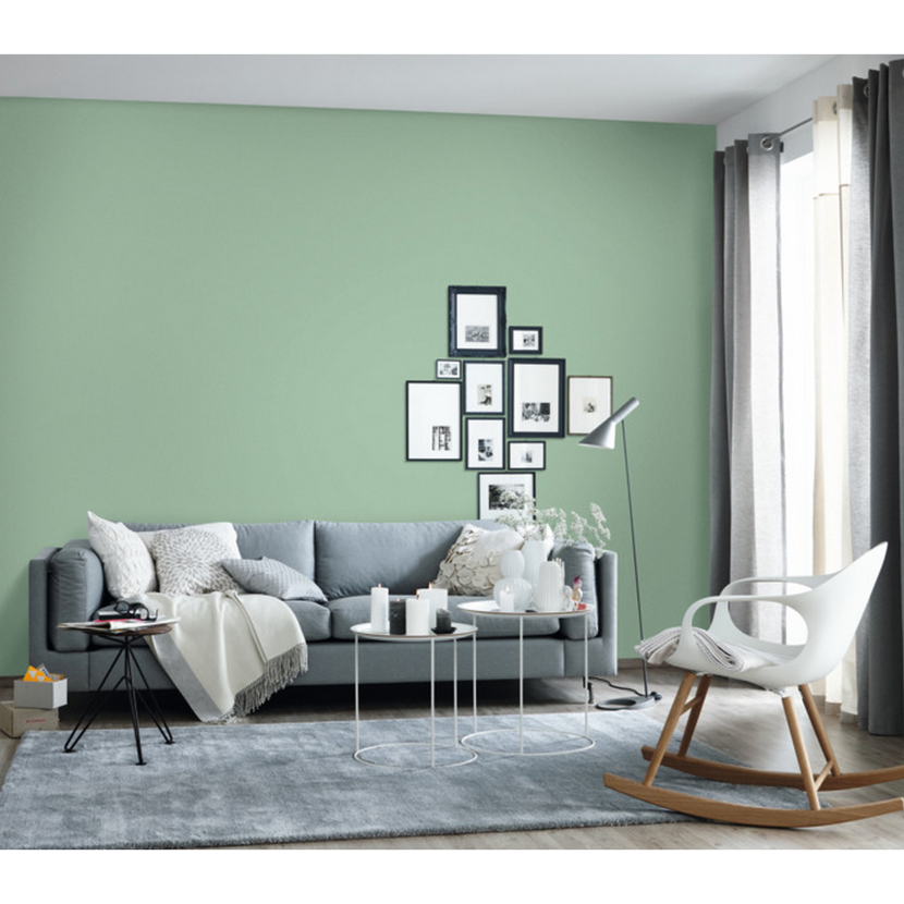 Wohnzimmer mit mintgrüner Wand und Sofa