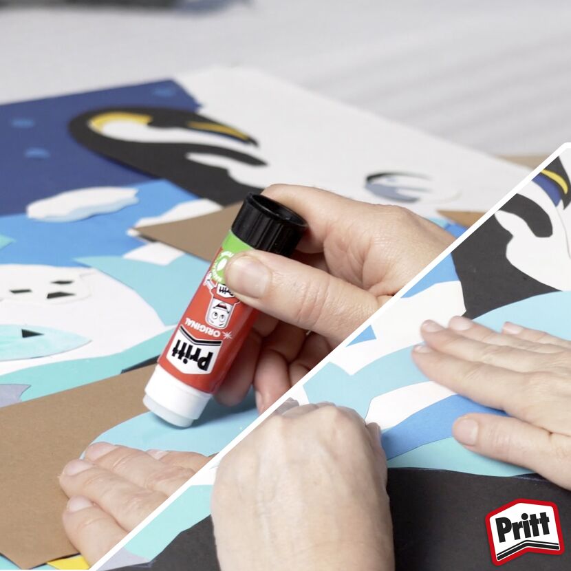 Person klebt Papier mit Pritt Stift