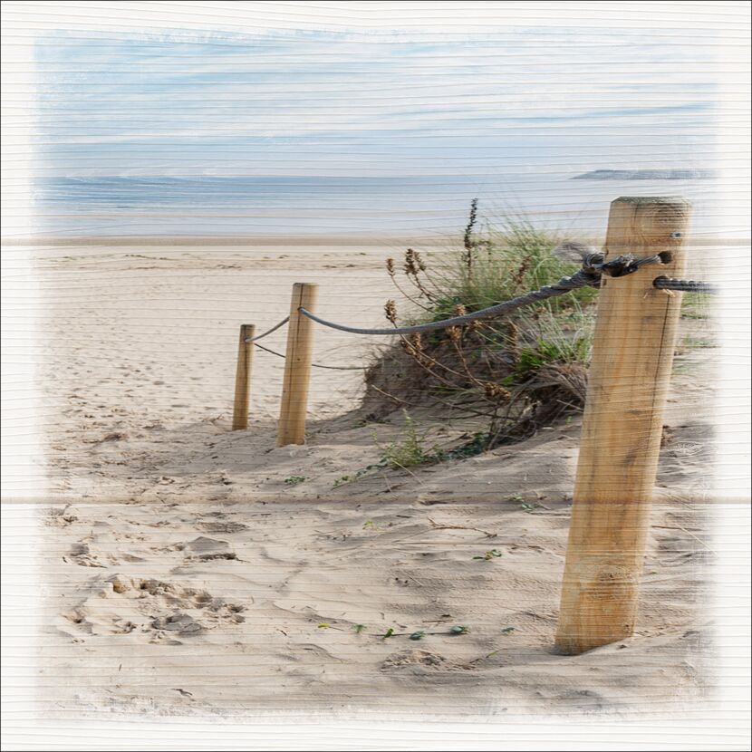 Strand mit Sand, Holzpfosten und Seil