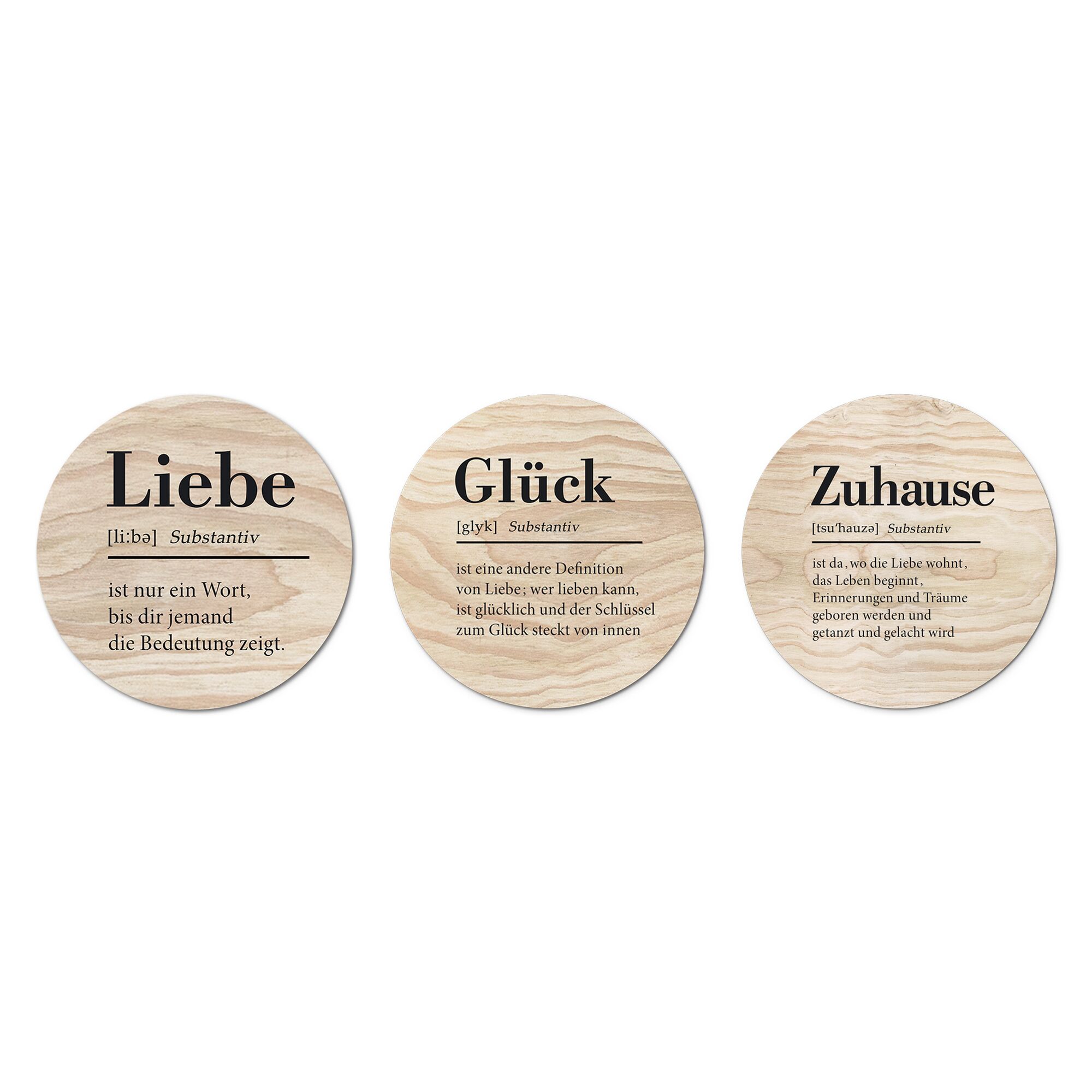 Drei runde Holzscheiben mit den Worten Liebe, Glück und Zuhause.