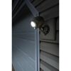 Brauner LED-Strahler leuchtet an Garagenwand.