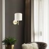 Goldene Wandleuchte mit weißem Lampenschirm