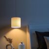 Hängelampe mit weißem Lampenschirm beleuchtet Schlafzimmer