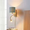 Goldene Wandleuchte mit petrolfarbenem Lampenschirm